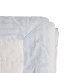"Made to order, this quilt is crafted with cotton fabric on both sides, featuring a blue-and-white striped edge and solid cotton reverse. It’s filled with soft cotton batting and machine washable on a gentle cycle."