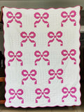 Handmade pink bow quilt with cotton patchwork, available in lap quilt, twin quilt. King and queen sizes. Perfect for girls’ room and dorm décor.