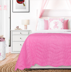 Handmade pink baby blanket on modern kids' bed with accent pillows, reversible cotton quilt, charming nursery bedding for girls, personalized monogram pillow decor.