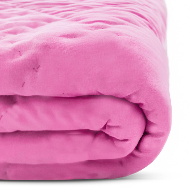 Handmade pink wave-stitched baby quilt on toddler bed, soft reversible cotton blanket, stylish nursery bedding for girls, perfect for personalized baby room decor.