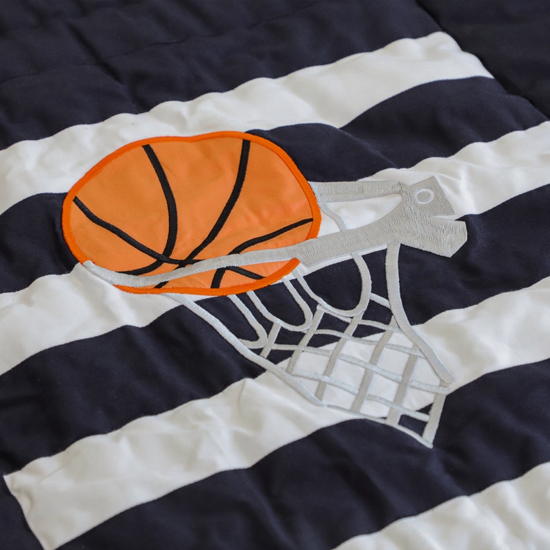 "Handcrafted athletic quilt for boys - features applique sports motifs, ideal for toddler beds or twin bedroom decor"