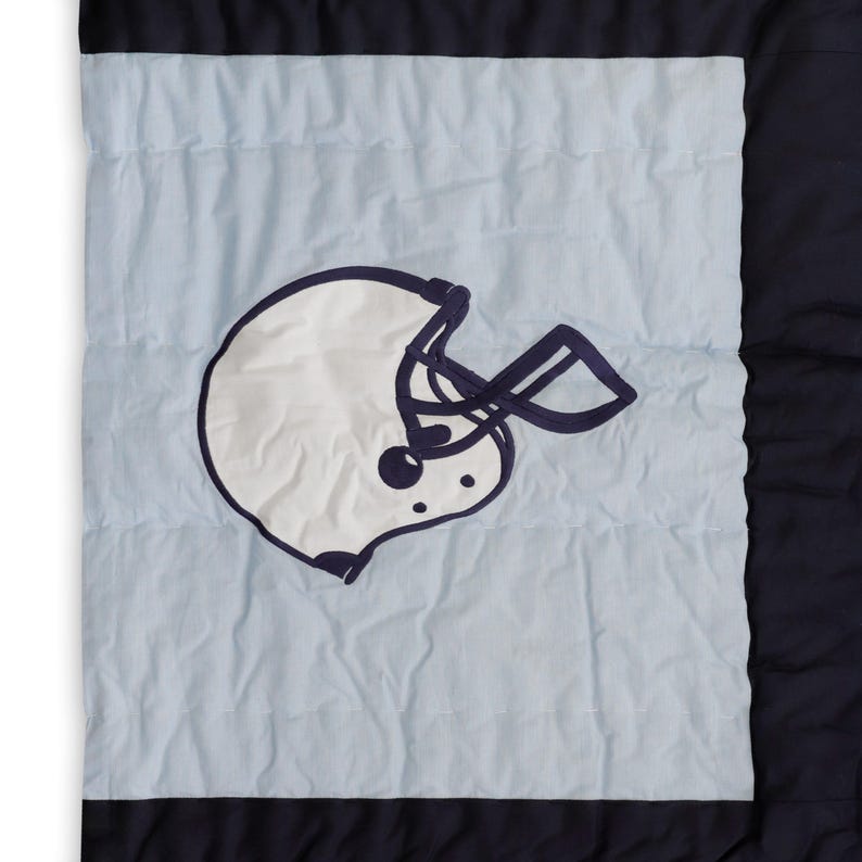 "Handcrafted toddler sports quilt - vibrant applique designs on cozy boys' bedding, perfect for little fans"