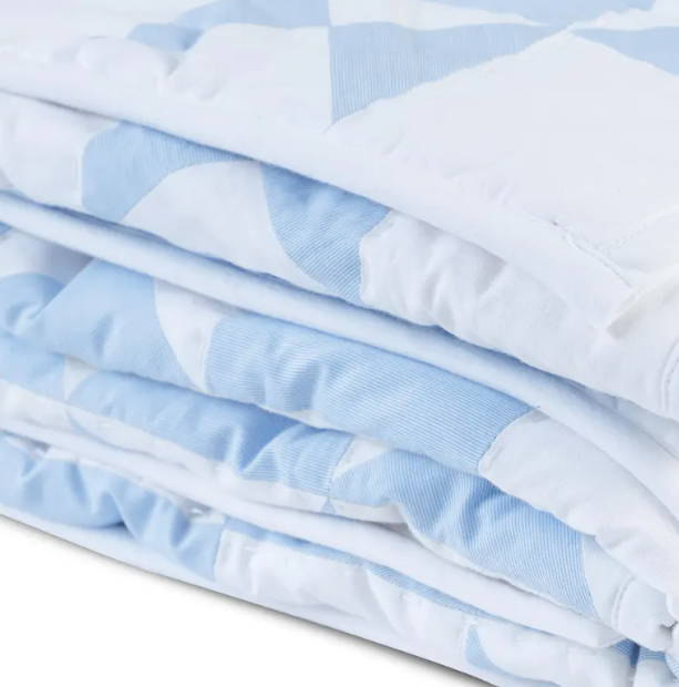 Handmade, breathable cotton quilt in a blue and white geometric pattern. Lightweight lap blanket, ideal for year-round use. Available in all sizes, including twin size beds and boys' dorm blankets.