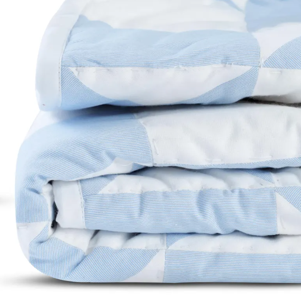 "Handcrafted minimalist quilt in blue & white, geometric triangles on lightweight fabric for year-round comfort."