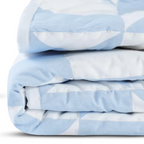 "Handcrafted minimalist quilt in blue & white, geometric triangles on lightweight fabric for year-round comfort."